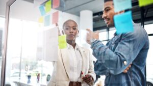 Two people looking at sticky notes