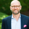 Man in suit coat wearing glasses